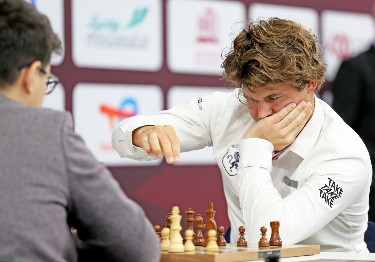 Norway's Magnus Carlsen (right) competes against Yagiz Kaan Erdogmus of Turkiye.