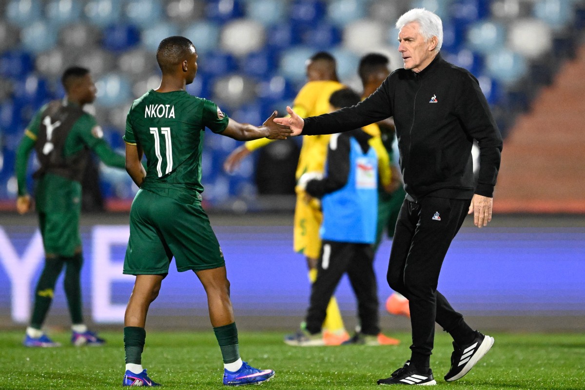 South Africa's head coach Hugo Broos shaks hands with South Africa's midfielder #11 Mohau Nkota after the Africa Cup of Nations (CAN) Group B football match between Zimbabwe and South Africa at Marrakesh Stadium in Marrakesh on December 29, 2025. (Photo by Khaled Desouki / AFP)
