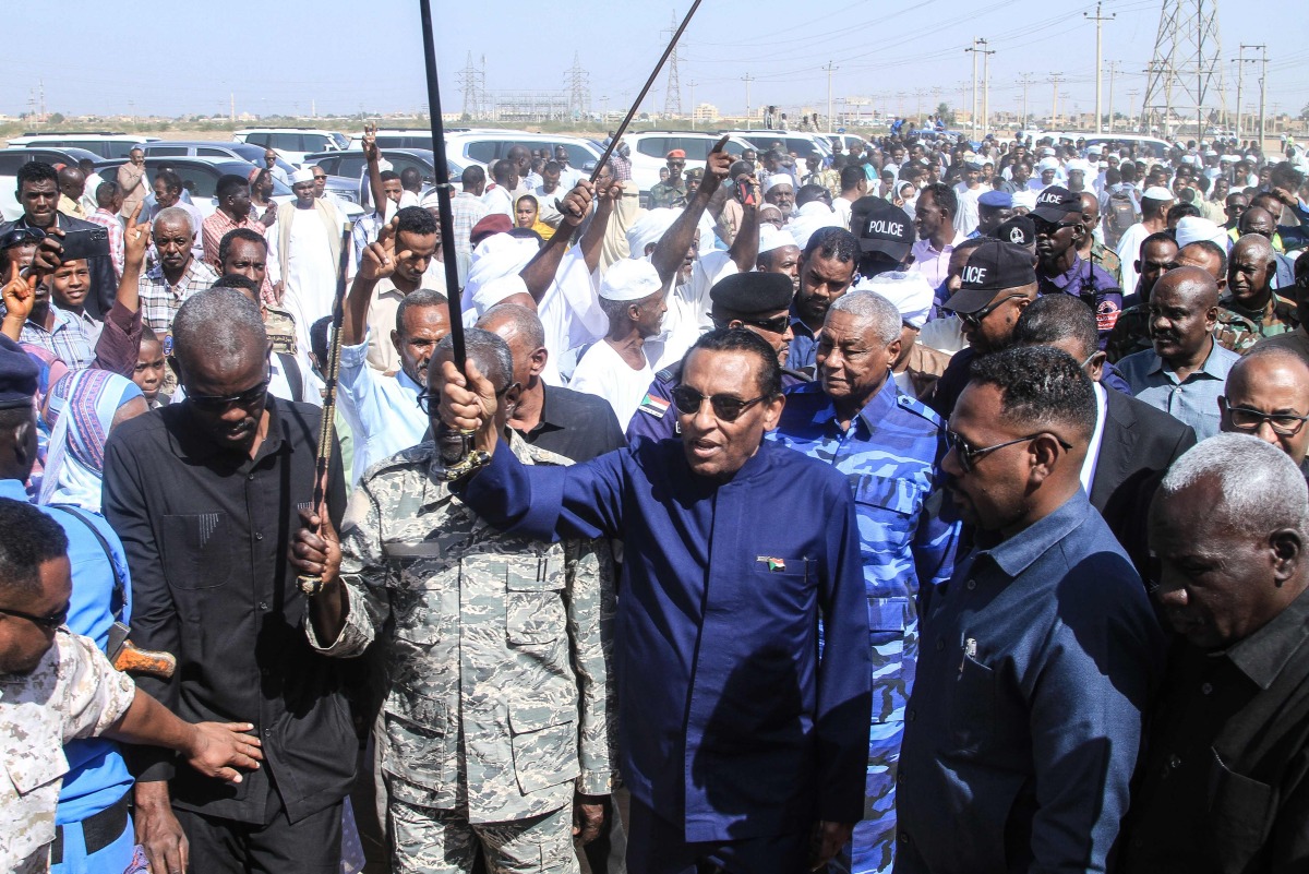 Sudan's Prime Minister Kamil Idris (front, C) waves as he arrives to deliver an address in Khartoum on January 11, 2026. Idris announced on January 11, 2026, the government's return to Khartoum, after nearly three years of operating from its wartime capital of Port Sudan. (Photo by Ebrahim HAMID / AFP)