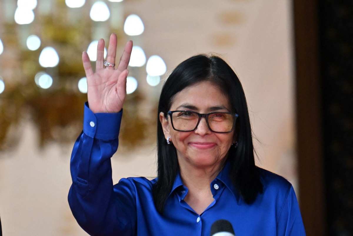 Venezuela's interim President Delcy Rodriguez waves after a press conference at the Presidential Palace in Caracas on January 14, 2026. (Photo by Juan BARRETO / AFP)
