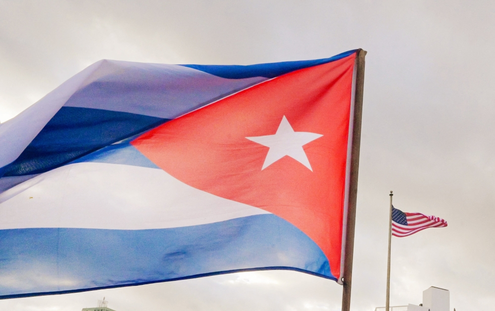 A Cuban soldier waves a national flag in front of the US Embassy in Havana on January 16, 2026. (Photo by Adalberto Roque / AFP)