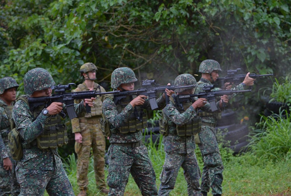 An Australian soldier (back L) supervises as Philippine Marines fire their weapons during a demonstration at Military Operation Urbanized Terrain (MOUTH) training exercises at the marine base in Ternate, Cavite province, southwest of Manila. File photo.