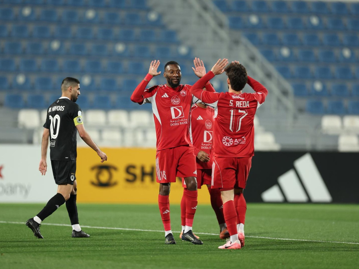 Karl Toko Ekambi (left) and Salem Reda celebrate a goal against Al Sadd yesterday. 