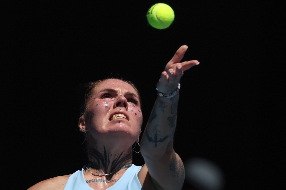 Ukraine's Oleksandra Oliynykova serves to USA's Madison Keys during their women's singles match on day three of the Australian Open tennis tournament in Melbourne on January 20, 2026. (Photo by Martin Keep / AFP) 