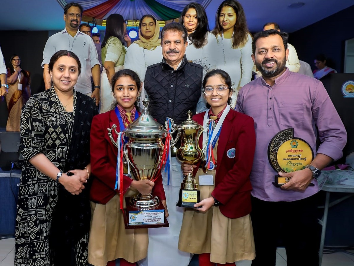 Students and teachers of Bhavan’s Public School pose with the trophies.
