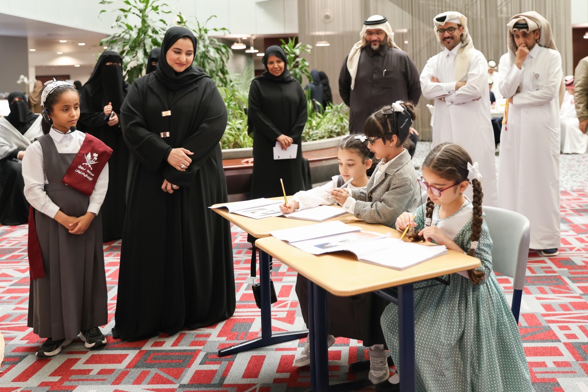 Officials watch pupils work during activities marking the education day.   