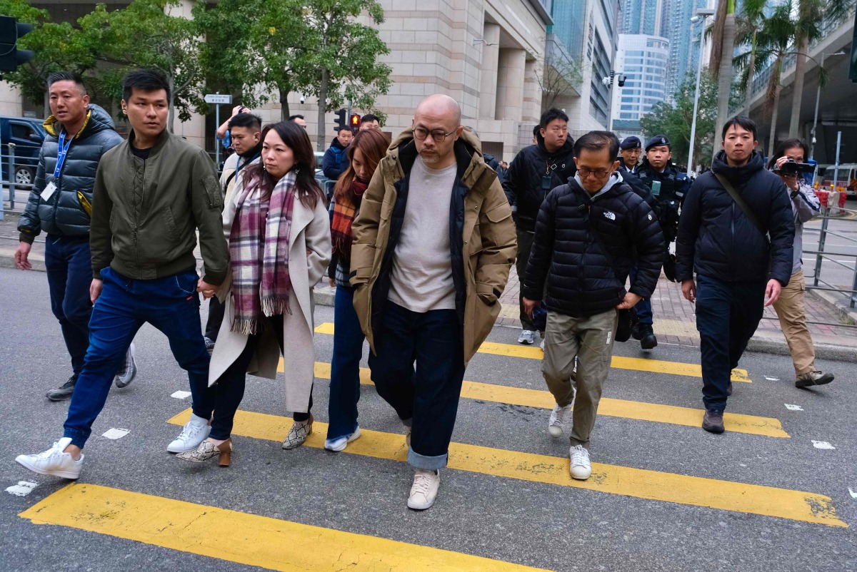 Relatives of Lamma IV ferry disaster victims leave Hong Kong's West Kowloon Law Courts Building after the city's coroner delivered the verdict on the accident, which killed 39 in total in 2012, on January 22, 2026. Photo by Tommy WANG / AFP