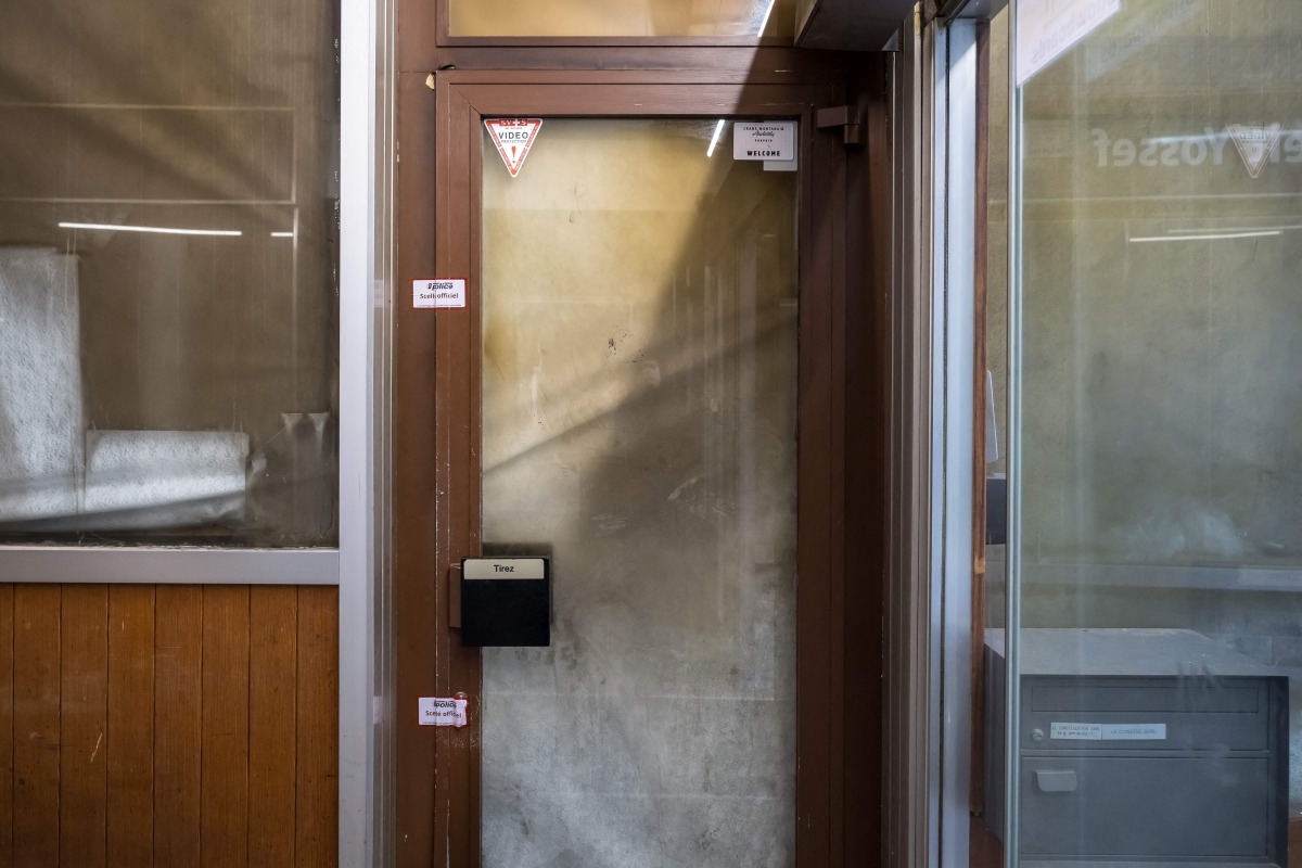 This photograph shows police seals on a door of the Le Constellation in the Alpine ski resort town of Crans-Montana on January 28, 2026, following the deadly fire that ripped through the venue on New Year's Eve celebrations. Photo by Fabrice COFFRINI / AFP