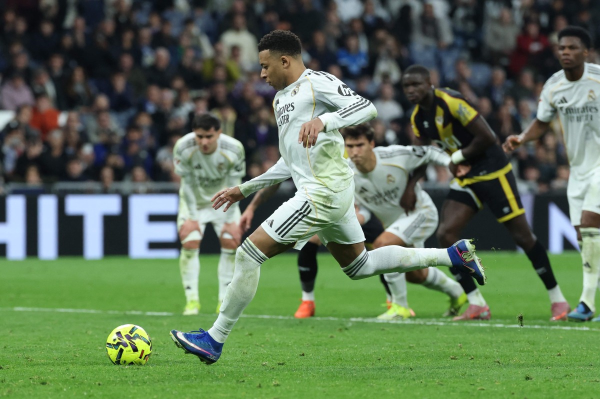 Real Madrid's French forward #10 Kylian Mbappe scores his team's second goal from the penalty spot during the Spanish league football match between Real Madrid CF and Rayo Vallecano at the Santiago Bernabeu stadium in Madrid on February 1, 2026. (Photo by Thomas COEX / AFP)