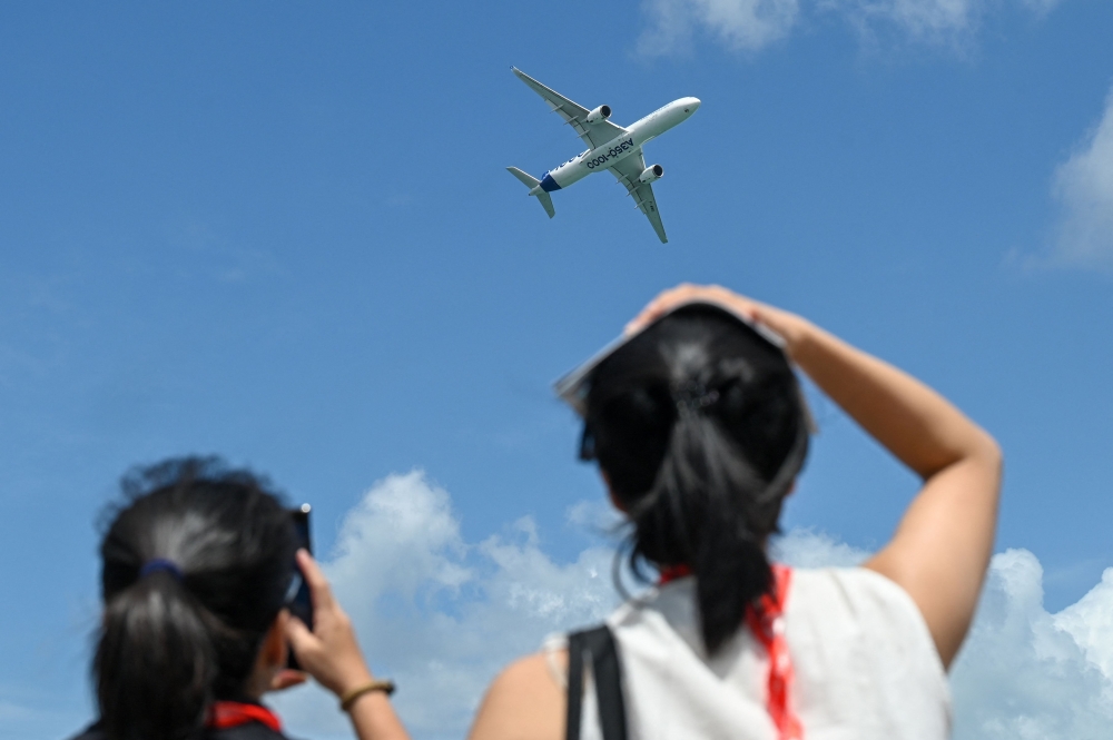 An Airbus' A350-1000 airliner takes part in an aerial display at the Singapore Airshow in Singapore on February 3, 2026. (Photo by Roslan Rahman / AFP)
