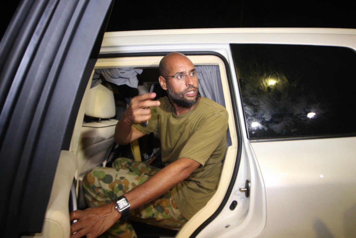 Seif al-Islam Kadhafi appears in front of supporters and journalists at his father's residential complex in the Libyan capital Tripoli in the early hours of August 23, 2011.