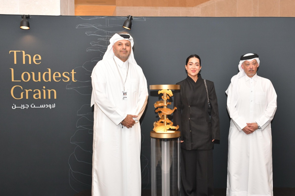 Chairman of Media City Qatar H E Sheikh Dr. Abdulla bin Ali Al-Thani (left), CEO of Media City Qatar Hamad Omar A Al-Mannai (right), and artist Yasamin Shaikhi with her winning artwork 'The Loudest Grain'.