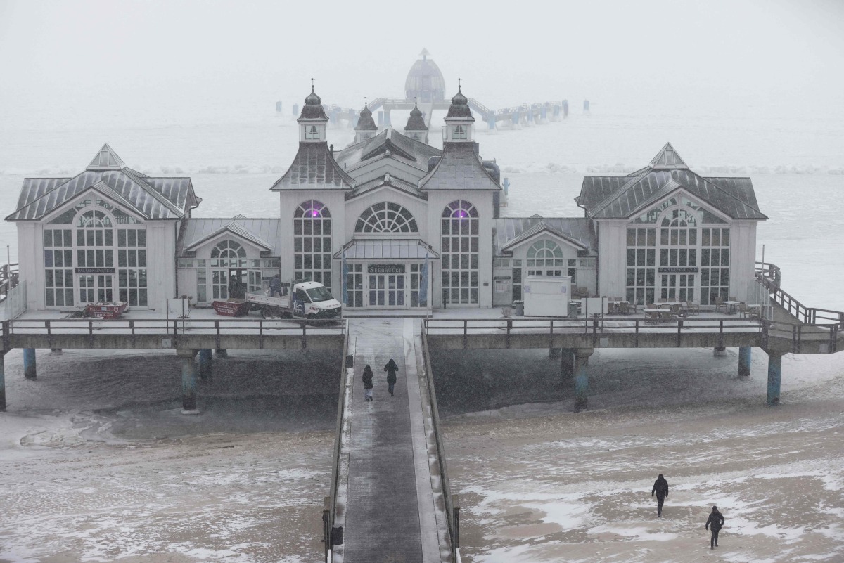 A pier is seen on the frozen ice cover over the Baltic sea in Sellin, northern Germany, on February 5, 2026. (Photo by Danny Gohlke / AFP)
