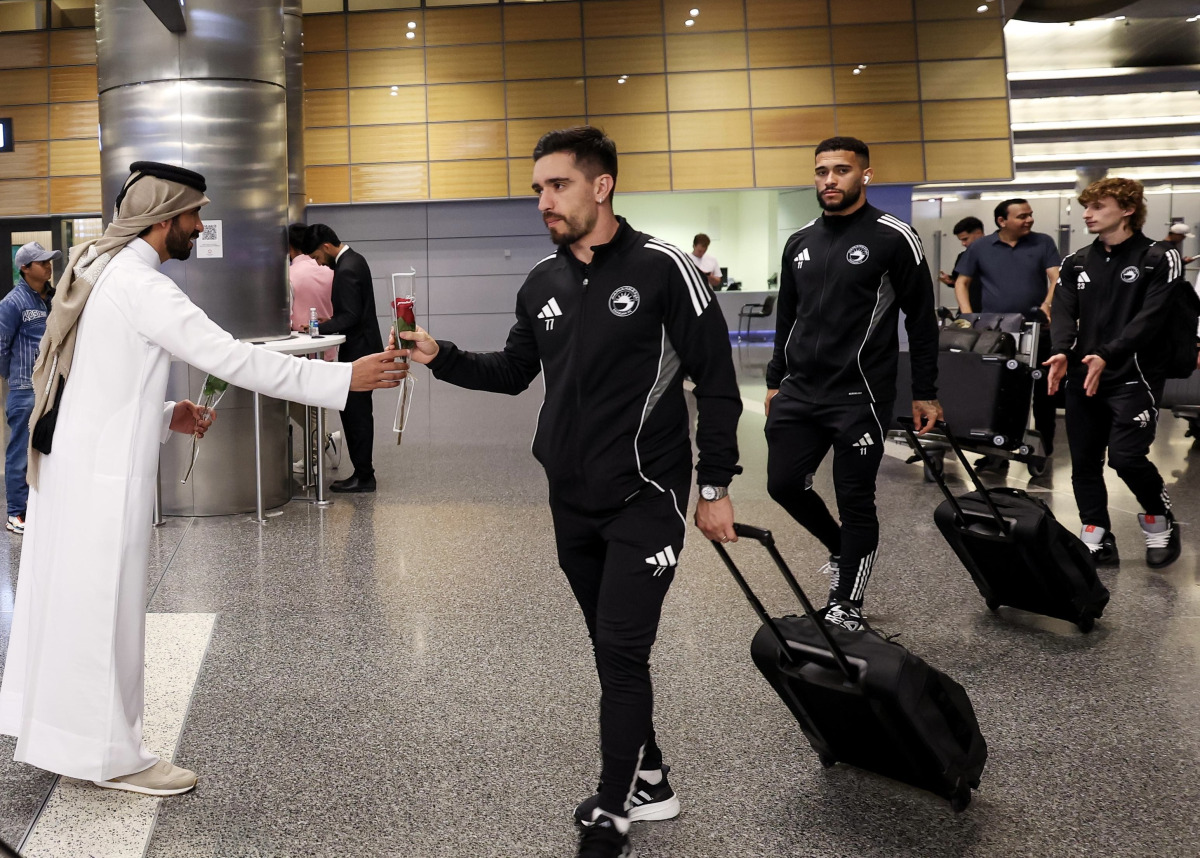 Sharjah players are welcomed upon their arrival in Doha.