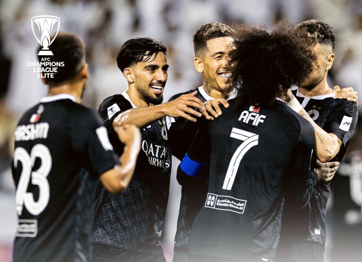 Al Sadd's players celebrate a goal.