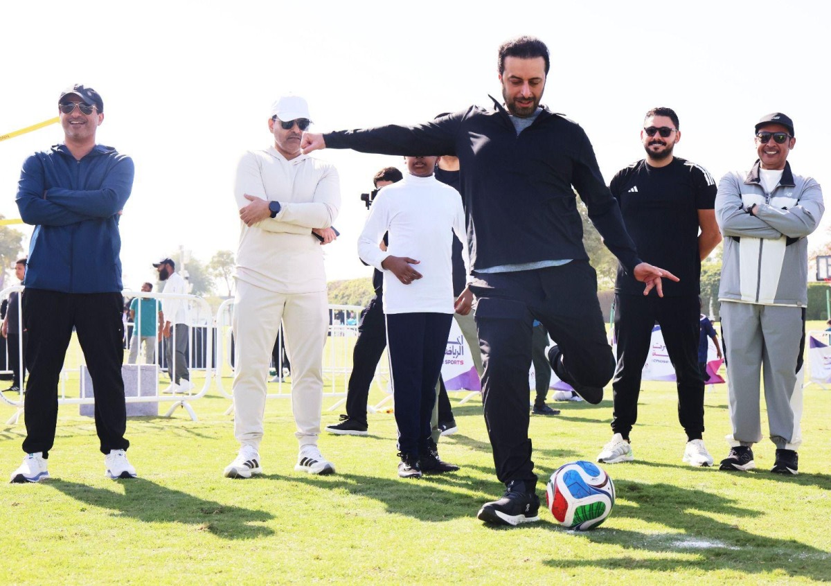 Minister of Municipality H E Abdullah bin Hamad bin Abdullah Al Attiyah playing football during the NSD event. 
