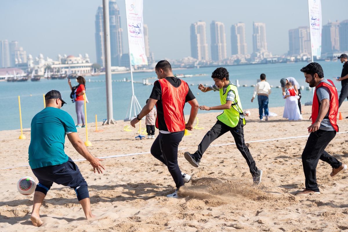 Participants playing football at Katara beach.