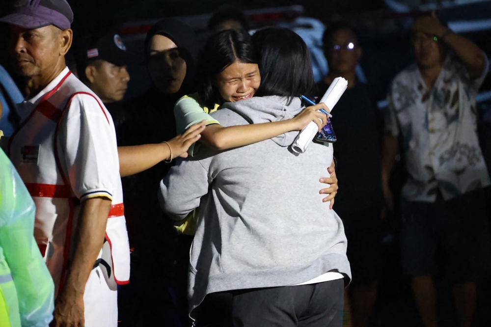 This handout photo released by the Songkhla Provincial Public Relations Office on February 11, 2026 shows a child reacting outside a school following a shooting near Hat Yai in southern Thailand's Songkhla province. (Photo by Handout / Songkhla Provincial Public Relations Office / AFP) 