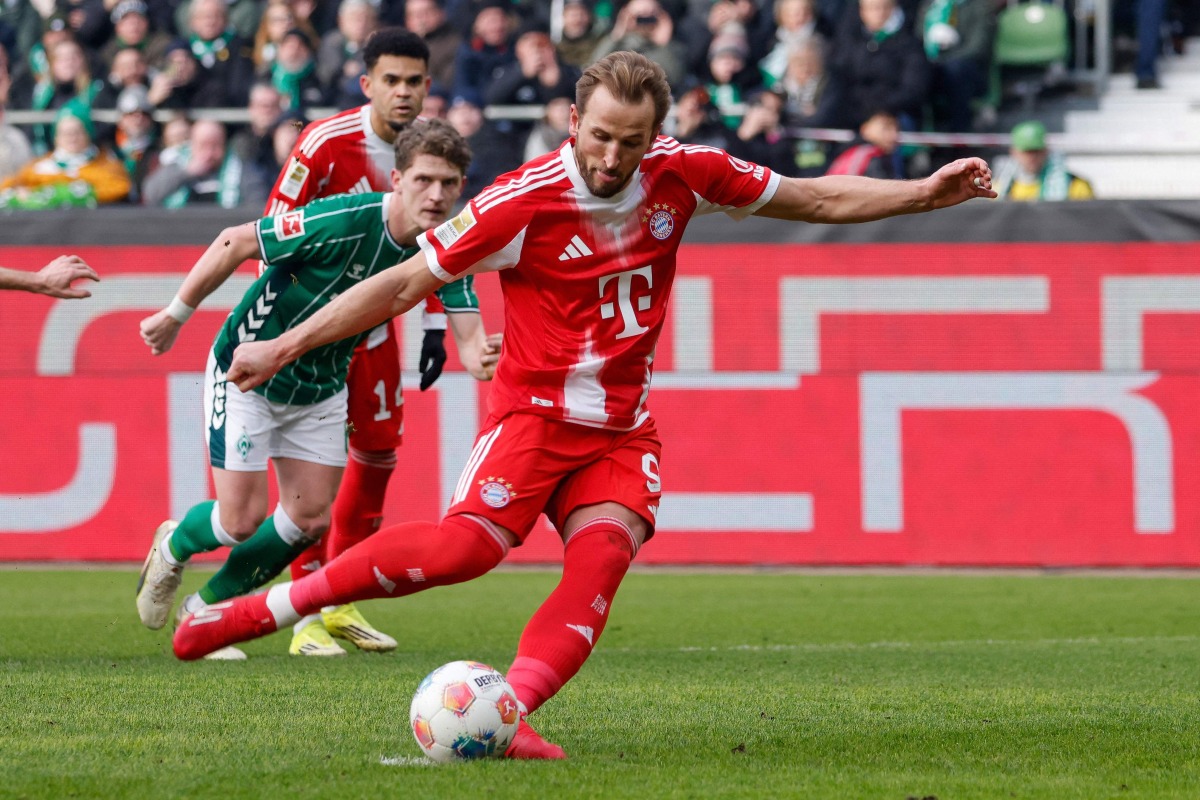 Bayern Munich's English forward #09 Harry Kane scores the opening goal from the penalty spot during the German first division Bundesliga football match between SV Werder Bremen and FC Bayern Munich in Bremen, northern Germany, February 14, 2026. (Photo by Focke Strangmann / AFP)