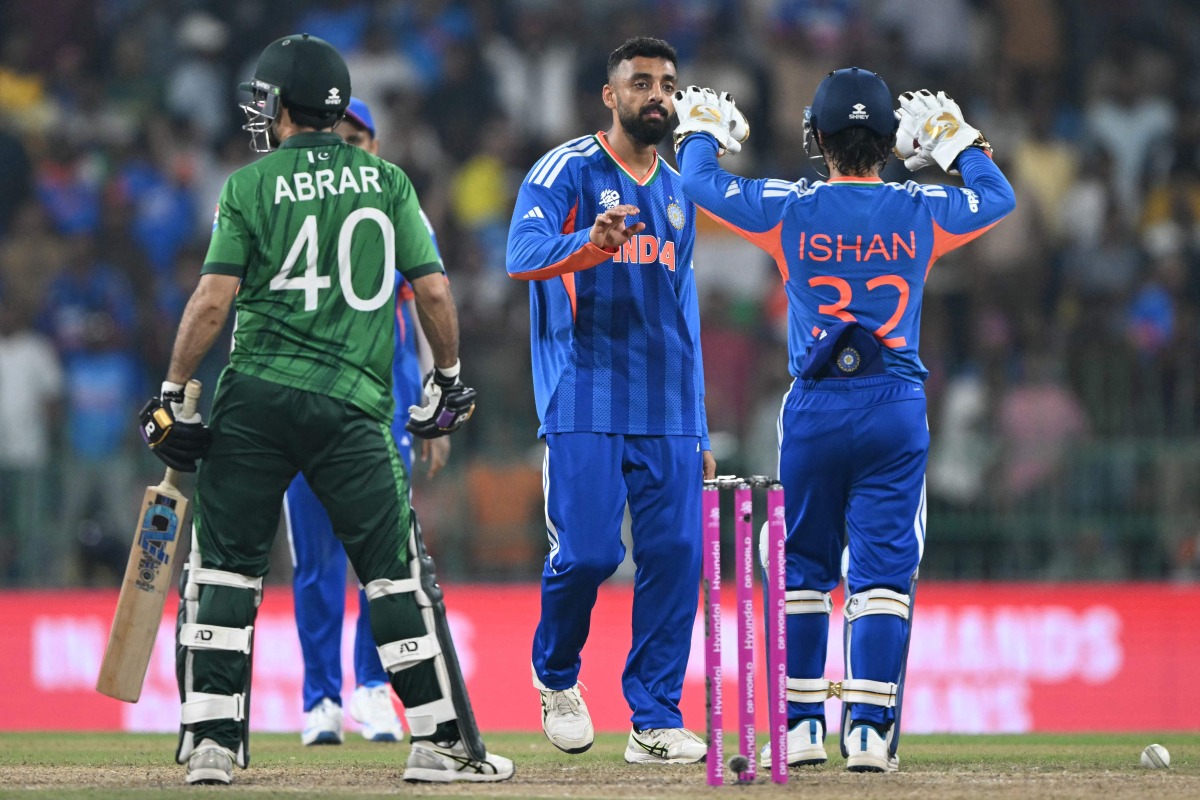 India's Varun Chakravarthy (C) celebrates with wicketkeeper Ishan Kishan after taking the wicket of Pakistan's Abrar Ahmed during the 2026 ICC Men's T20 Cricket World Cup group stage match between India and Pakistan at the R Premadasa Stadium in Colombo on February 15, 2026. (Photo by Ishara S.KODIKARA / AFP)