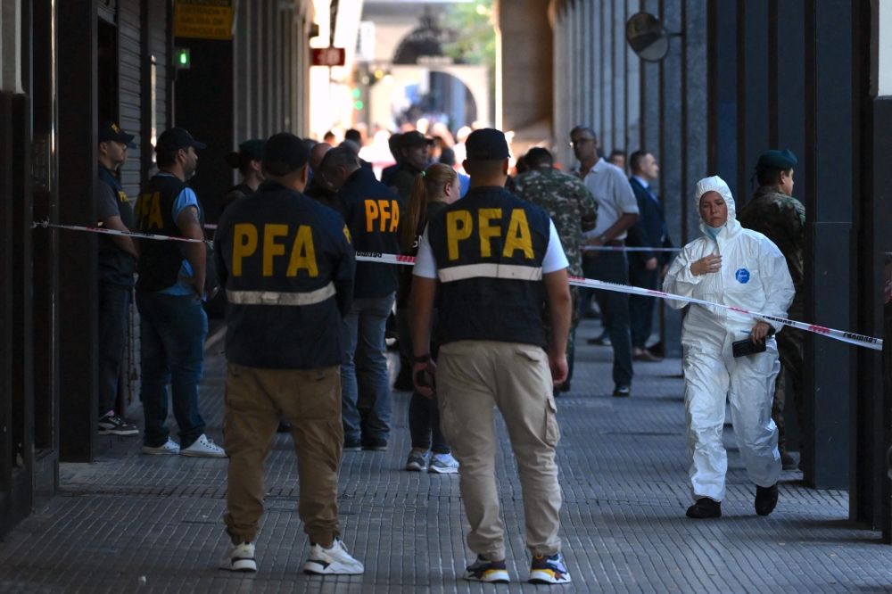 First responders work at the entrance of the Superior Gendarmerie School in Buenos Aires on February 20, 2026, after a mail package exploded. Three people were injured on February 20 by the explosion of a mail package at the Superior Gendarmerie School in Buenos Aires. (Photo by Luis Robayo / AFP)