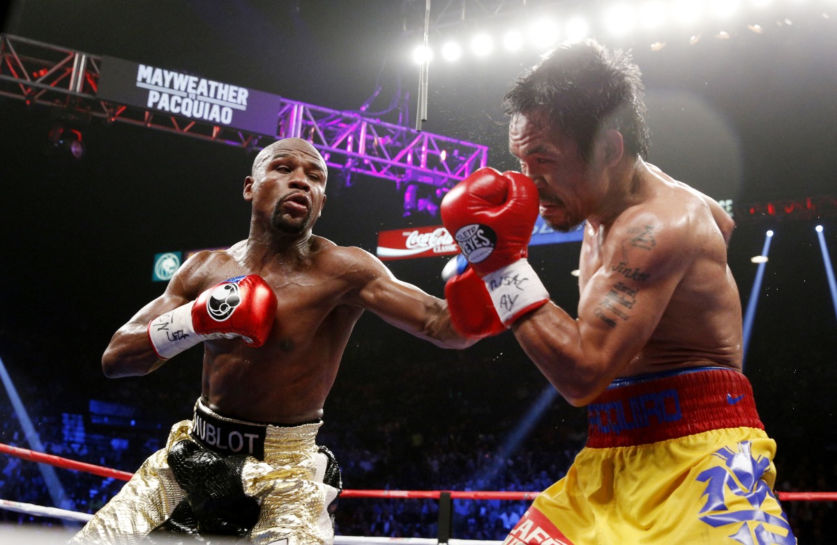 Floyd Mayweather (left) exchange punches with Manny Pacquiao during their welterweight unification championship bout in Las Vegas, Nevada in this in this May 2, 2015 file photo.