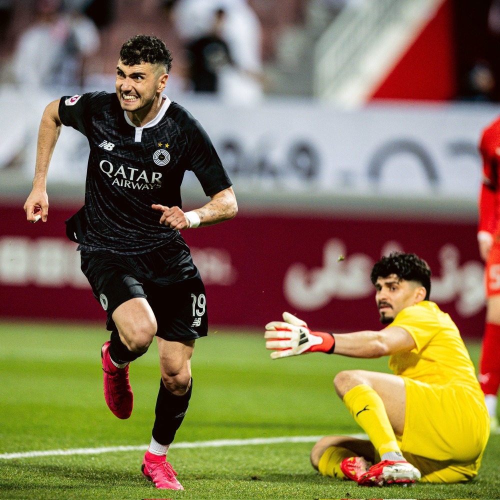 Rafa Mujica (left) celebrates after scoring Al Sadd's second goal.