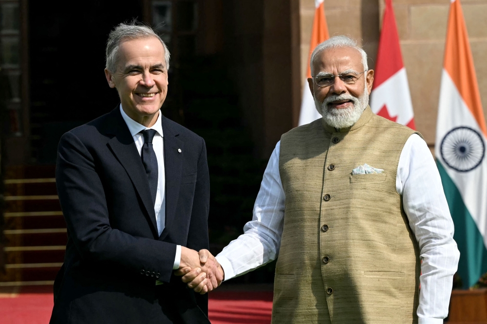 India's Prime Minister Narendra Modi (R) shakes hands with his Canadian counterpart Mark Carney before their meeting at the Hyderabad House in New Delhi on March 2, 2026. (Photo by Sajjad Hussain / AFP)