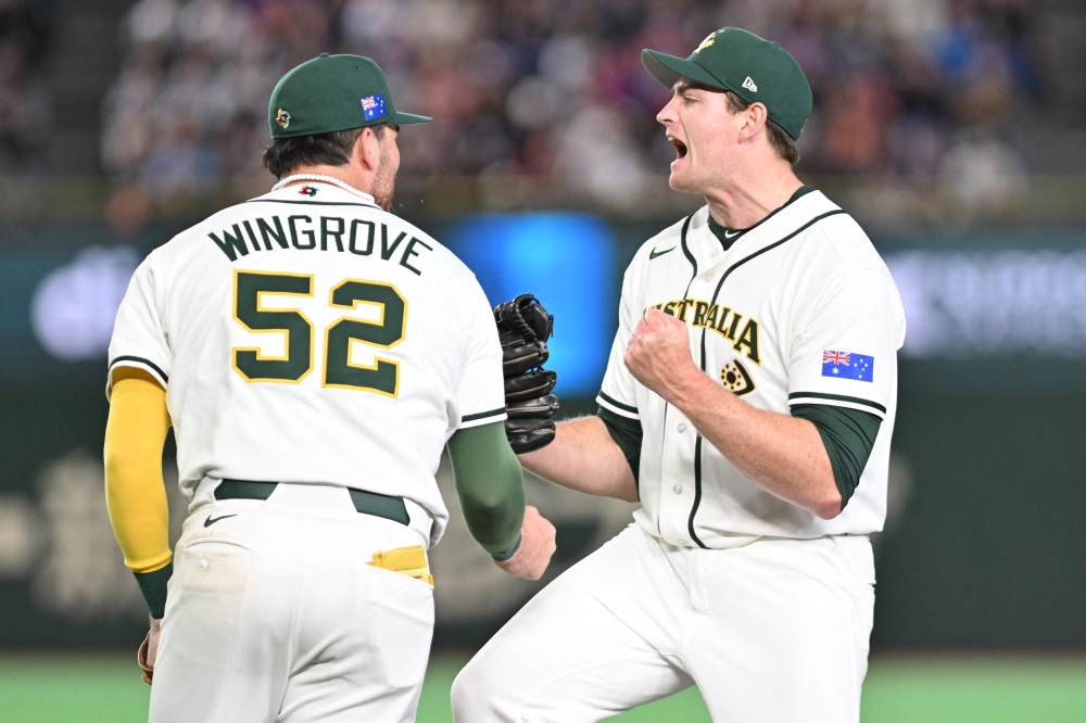 Australia's closing pitcher Jon Kennedy (R) celebrates victory over Taiwan at the World Baseball Classic (WBC) Pool C first round game between Australia and Taiwan at the Tokyo Dome on March 5, 2026. (Photo by Kazuhiro Nogi/ AFP) 