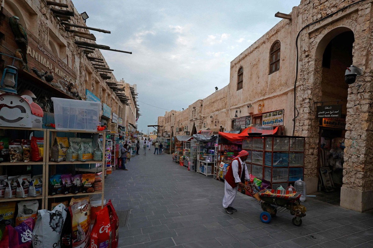 Visitors walk through a bird market at Souq Waqif in Doha on March 4, 2026. Photo by Karim JAAFAR / AFP