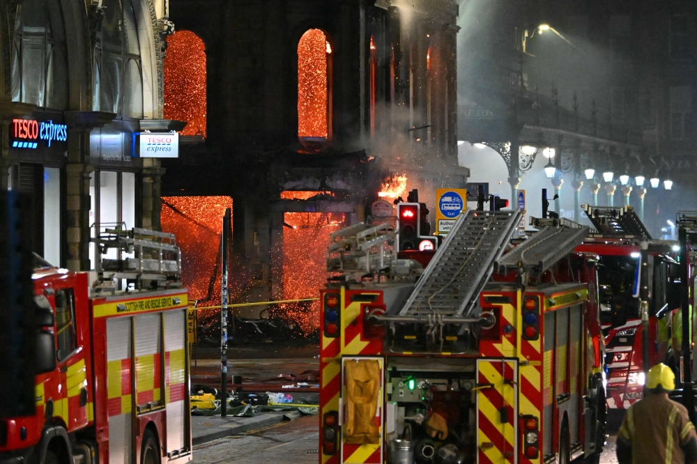 Floors collapse inside the building as fire fighters work at the site of a large fire in Glasgow City centre on March 8, 2026. (Photo by Andy Buchanan / AFP)