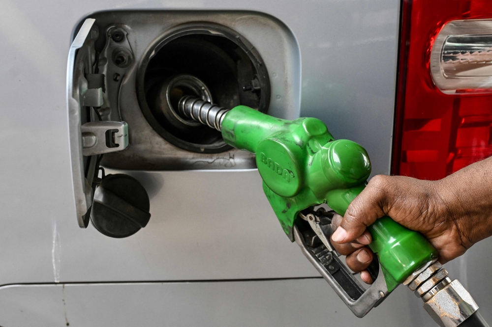 A worker refuels a car at a filling station in Dhaka on March 9, 2026. (Photo by Munir Uz Zaman / AFP)