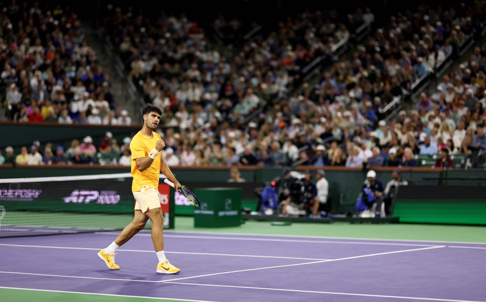 Carlos Alcaraz of Spain celebrates a point against Arthur Rinderknech of France in their third-round match of the BNP Paribas Open at Indian Wells Tennis Garden on March 09, 2026 in Indian Wells, California. Photo by Clive Brunskill/ AFP)