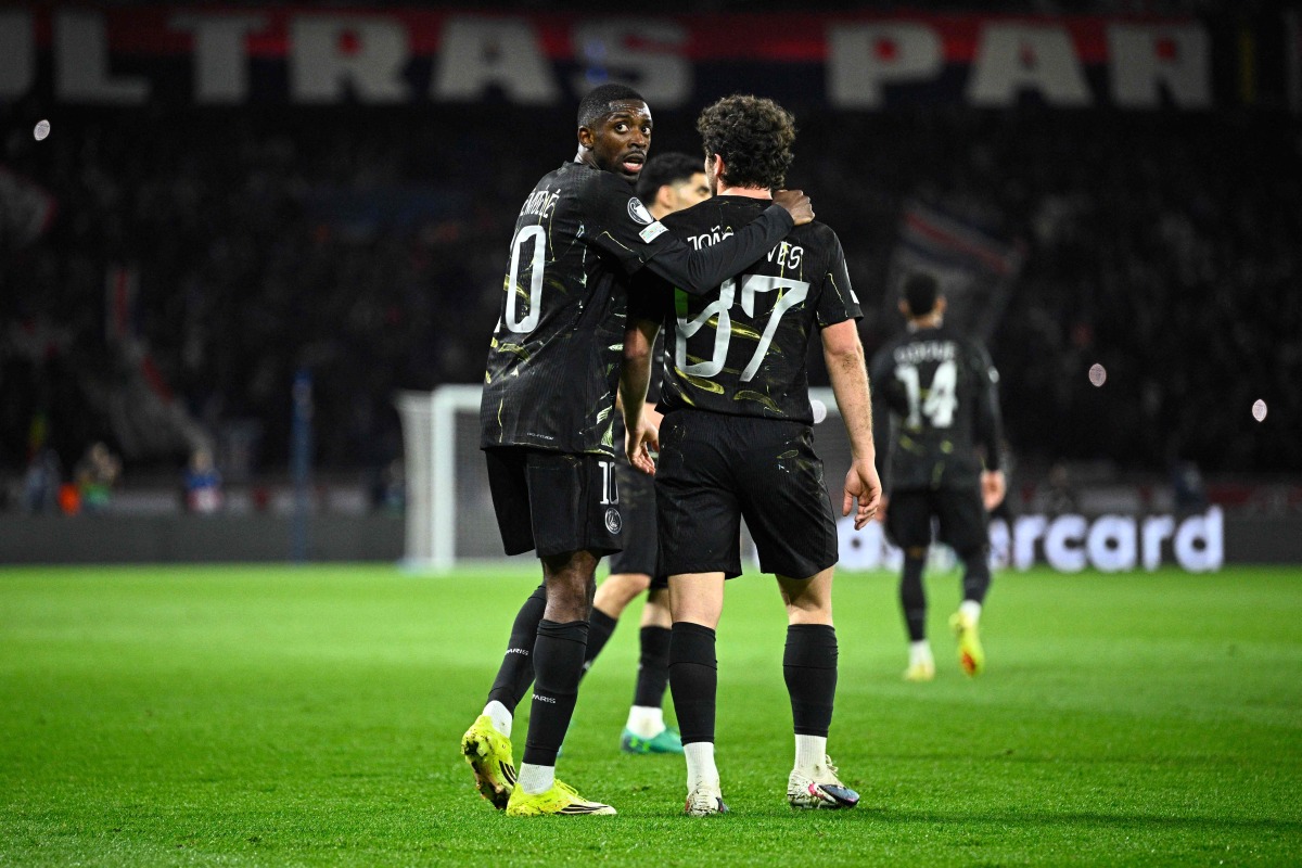 Paris Saint-Germain's French forward #10 Ousmane Dembele (L) reacts with Paris Saint-Germain's Portuguese midfielder #87 Joao Neves during the UEFA Champions League round of 16 first leg football match between Paris Saint-Germain (PSG) and Chelsea at the Parc des Princes stadium in Paris on March 11, 2026. (Photo by JULIEN DE ROSA / AFP)