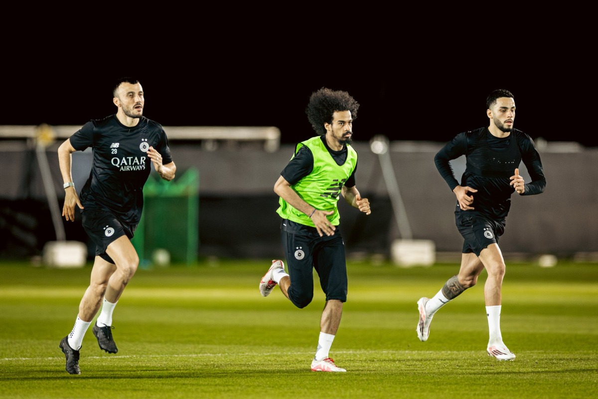 Al Sadd's Akram Afif (centre) trains with teammates.