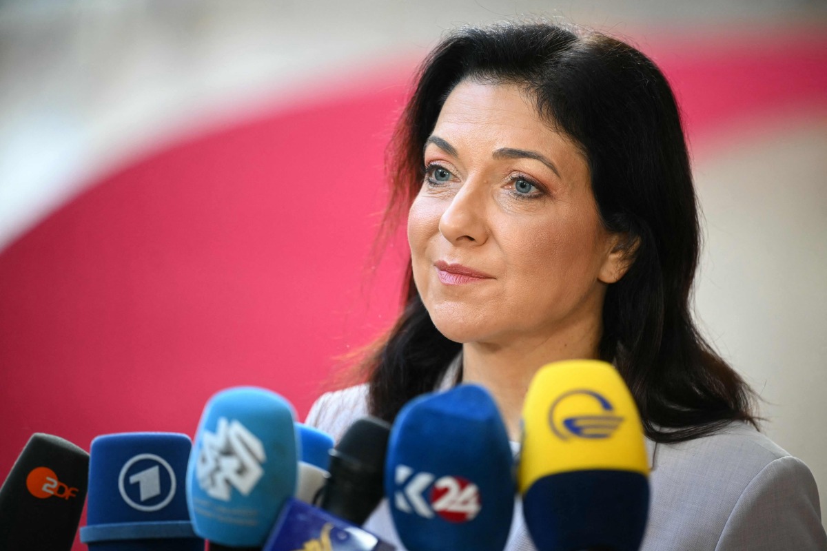 Germany's Economy and Energy Minister, Katherina Reiche speaks to the media as she arrives for a Transport, Telecommunications and Energy Council in Brussels on March 16, 2026. (Photo by NICOLAS TUCAT / AFP)