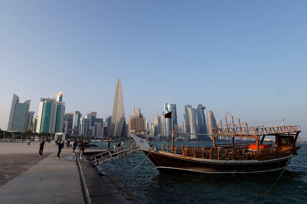 Families walk along the Corniche on the second day of Eid al-Fitr celebrations in Doha on March 21, 2026. (Photo by AFP) 