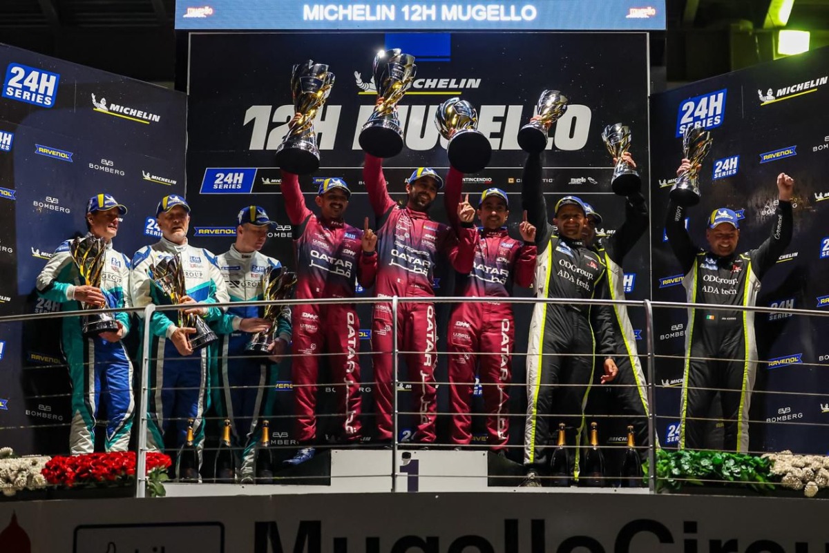 Team Qatar drivers celebrate their victory on the podium.