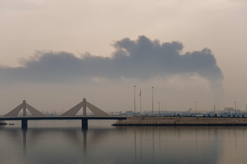 (Files) A plume of smoke rises after a reported Iranian strike on fuel tanks in Muharraq on March 12, 2026. (Photo by Fadhel Madhan / AFP)