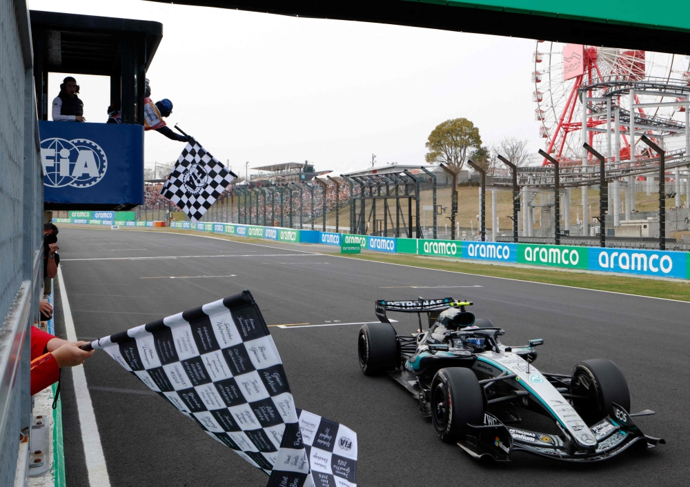Mercedes' Italian driver Kimi Antonelli crosses the finish line to win the Formula One Japanese Grand Prix at the Suzuka circuit in Suzuka, Mie prefecture on March 29, 2026. (Photo by Franck Robichon / Pool / AFP)