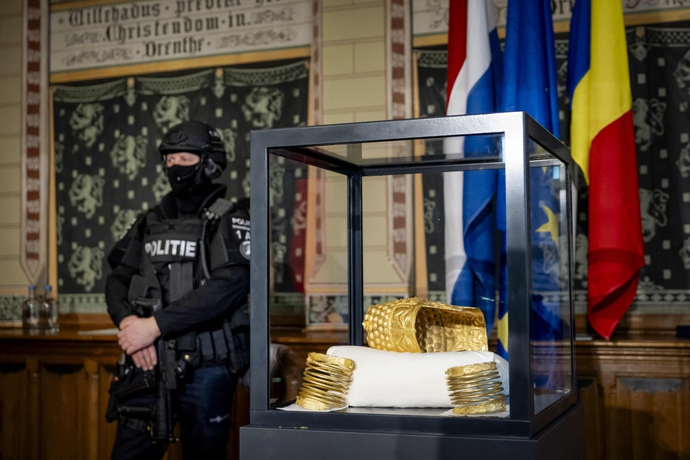 The recovered golden helmet of Cotofenesti and two gold bracelets that were stolen from the Drents Museum are displayed in a glass box in Assen on April 2, 2026. (Photo by Sem van der Wal / ANP / AFP) 