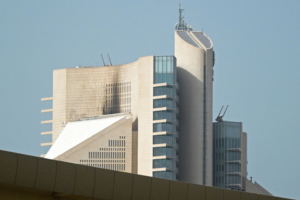 This photograph shows the impact of a fire caused by a drone attack on a building of the Kuwait Petroleum Corporation (KPC), in Kuwait City on April 5, 2026. (Photo by AFP)