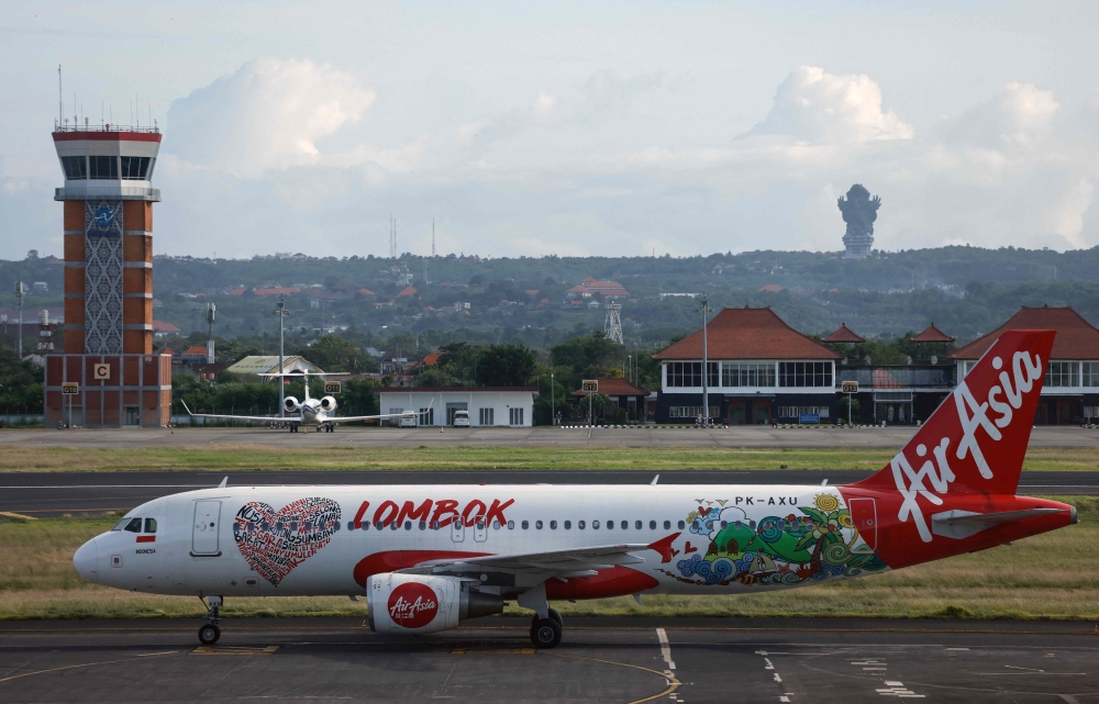 (Files) An AirAsia Airbus A320 passenger aircraft taxis after landing at the I Gusti Ngurah Rai International Airport in Bali on January 21, 2024. (Photo by David Gannon / AFP)