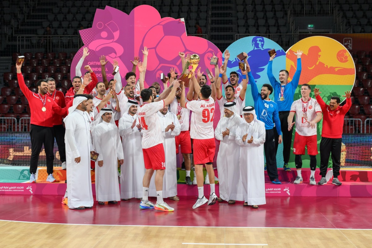 Second Vice President of the Qatar Olympic Committee Dr. Thani bin Abdulrahman Al-Kuwari, and Qatar Handball Federation President Ahmed Mohammed Al-Shaabi applaud as Al Arabi players celebrate their triumph.