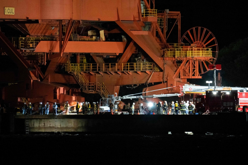 Emergency workers are seen at the JFE Steel East Japan Works Keihin District construction site, where scaffolding collapsed in Kawasaki, Kanagawa prefecture on April 7, 2026. (Photo by Yuichi Yamazaki / AFP)