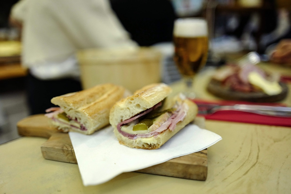 This photograph shows a butter, ham, cheese and pickles baguette sandwich at the counter of Le Petit Vendome cafe bistrot in Paris on September 16, 2025. Photo by Ludovic MARIN / AFP