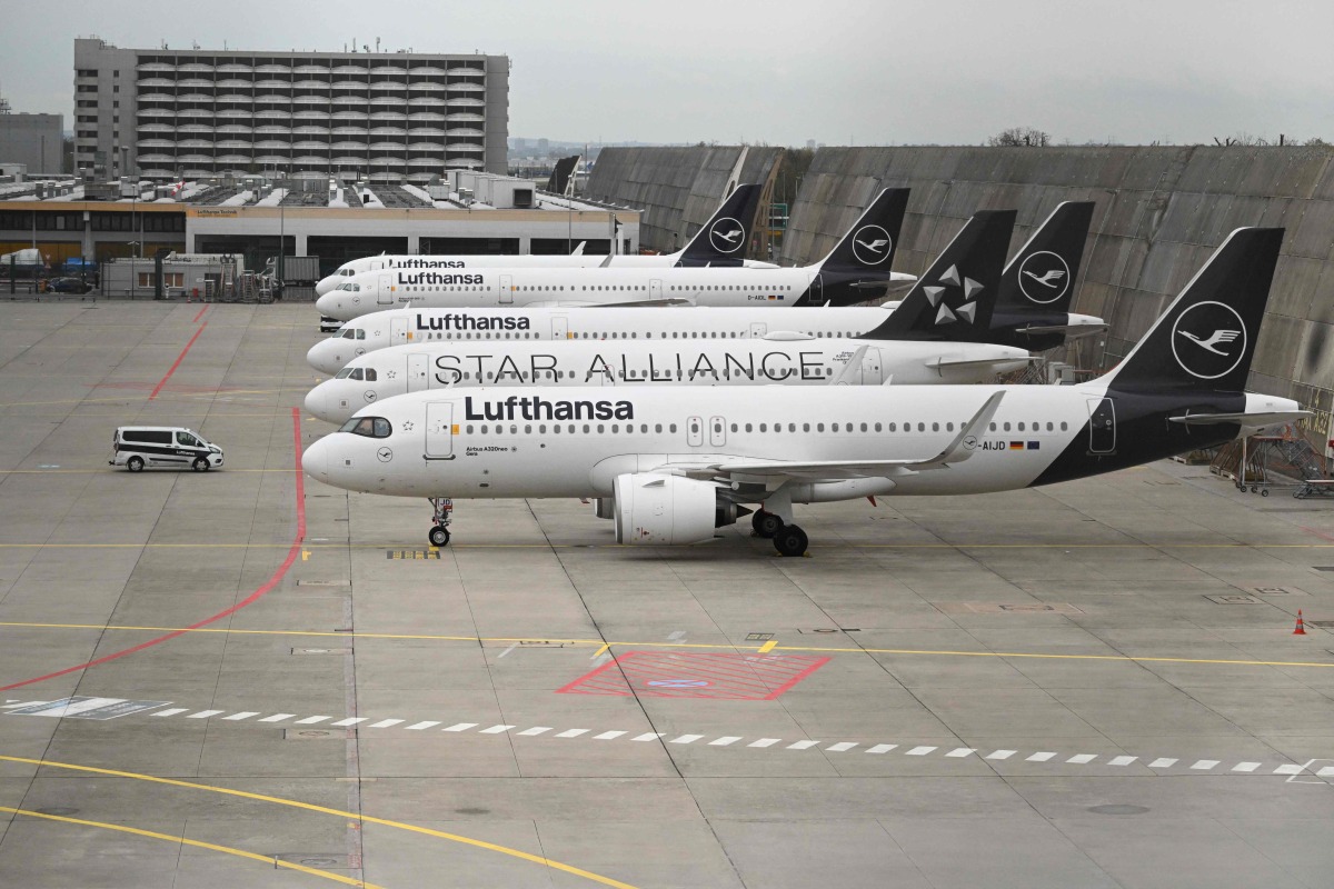 Planes operated by German airline Lufthansa sit on the tarmac at Frankfurt Airport in Frankfurt am Main, on April 10, 2026 as cabin crews went on strike over an ongoing labour dispute. (Photo by Kirill KUDRYAVTSEV / AFP)