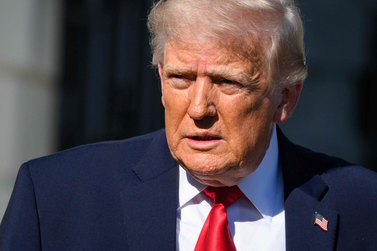 US President Donald Trump walks towards reporters before boarding Marine One to depart from the White House in Washington, DC, on April 11, 2026. (Photo by Mandel NGAN / AFP)