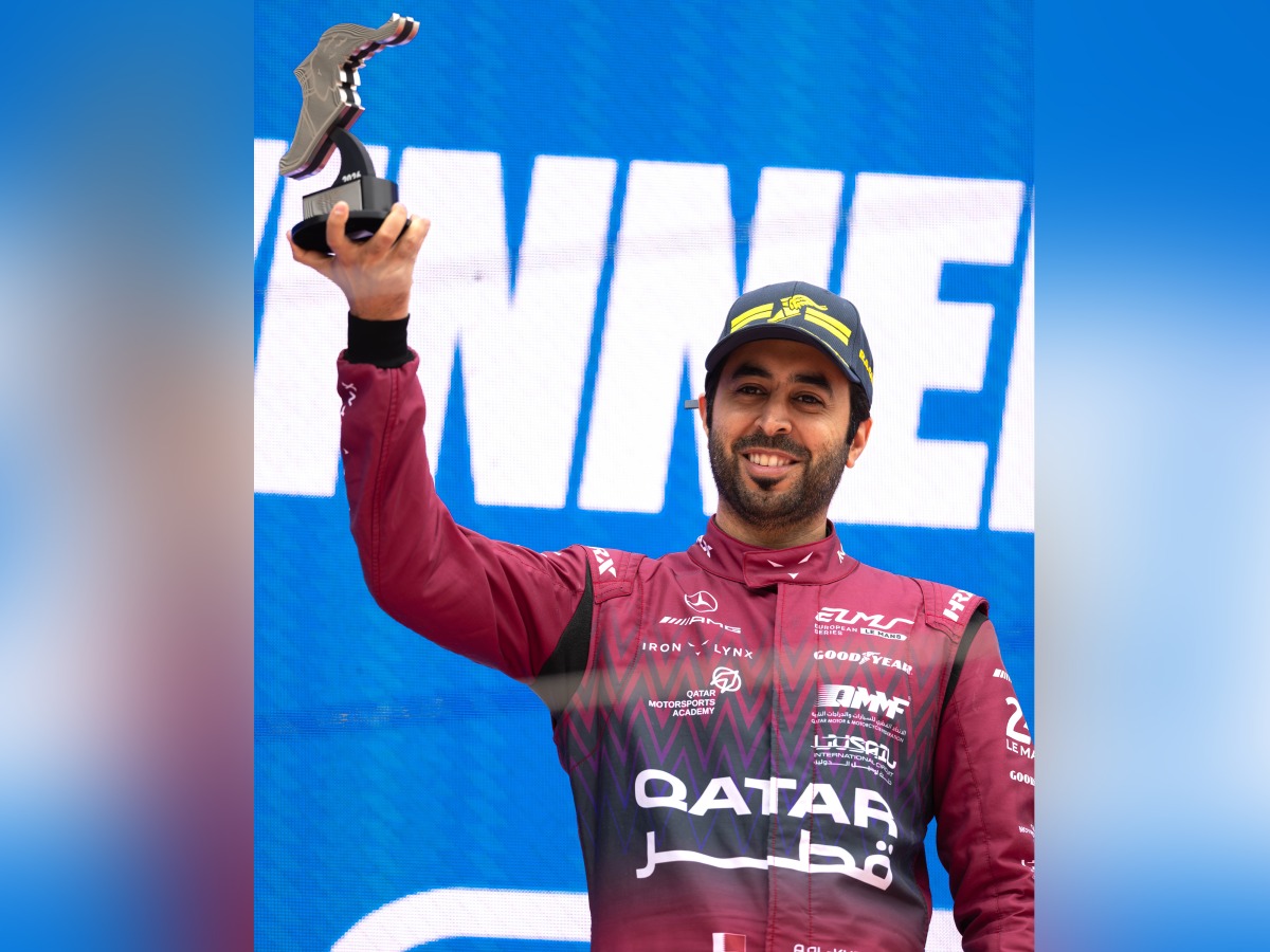 Qatari driver Abdulla Al Khelaifi celebrates on the podium after winning the Most Valuable Driver award in the LMGT3 class.