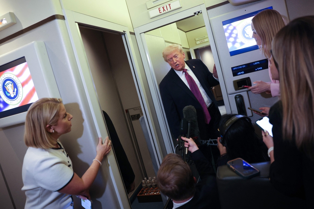 US President Donald Trump speaks to members of the press aboard Air Force One on April 17, 2026 just prior to landing at Joint Base Andrews, Maryland. Win McNamee/Getty Images/AFP